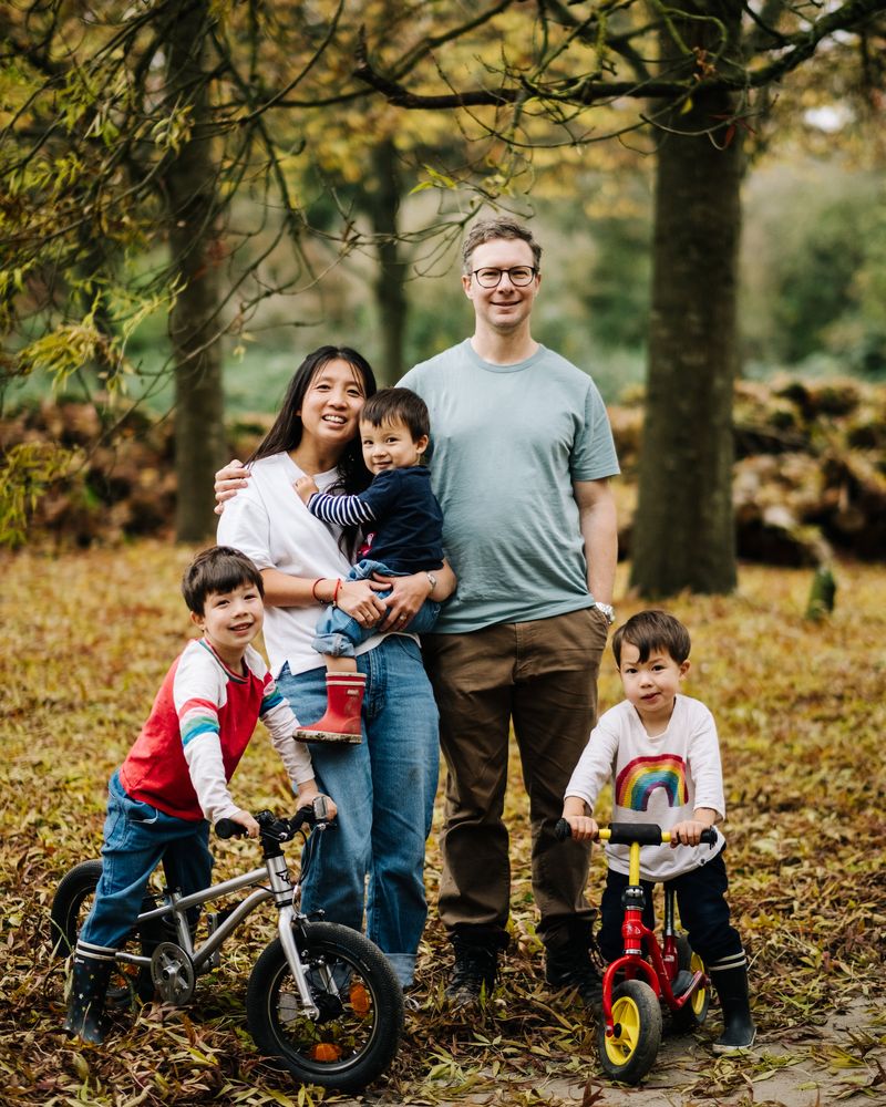 The Nestegg Rentals family — Richard and Kanli Davies with their three children — out together in an autumn woodland.